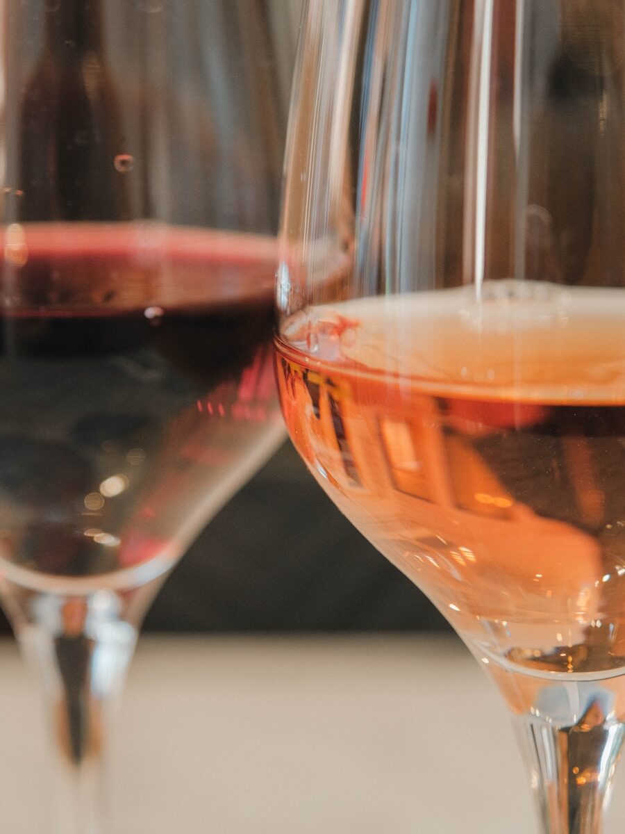 Two glasses of wine, one red, one rosé.